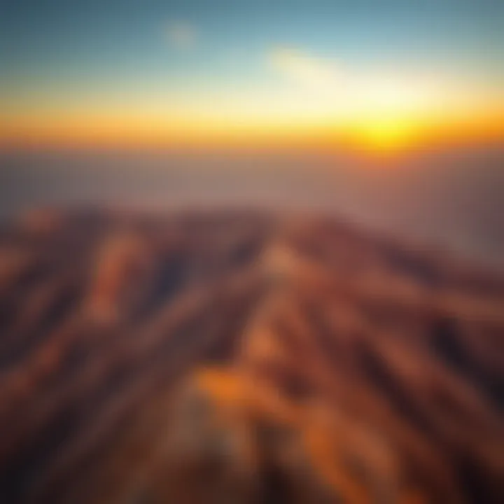 An aerial view of Jebel Hafeet mountain showcasing its rugged terrain and stunning sunset